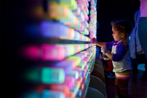 child playing with interactivbe exhibit